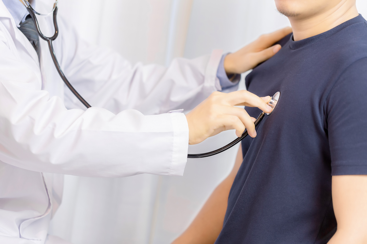 Doctor examination young man with stethoscope in hospital. healthcare and medicine